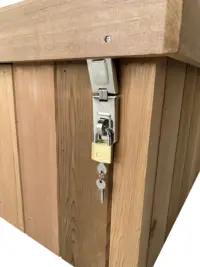 Storage bench lock securing the lid to the side of the bench with a hasp and staple and added padlocks